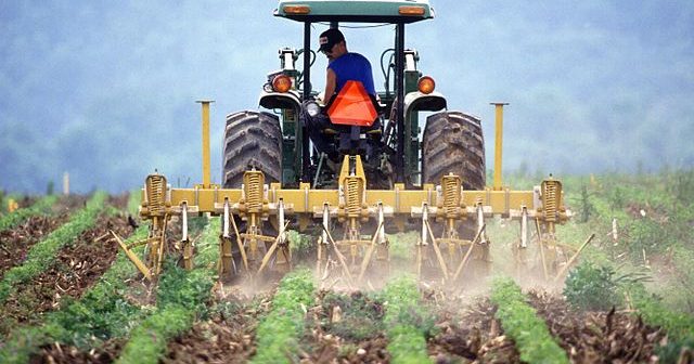 640px-Farmer_and_tractor_tilling_soil